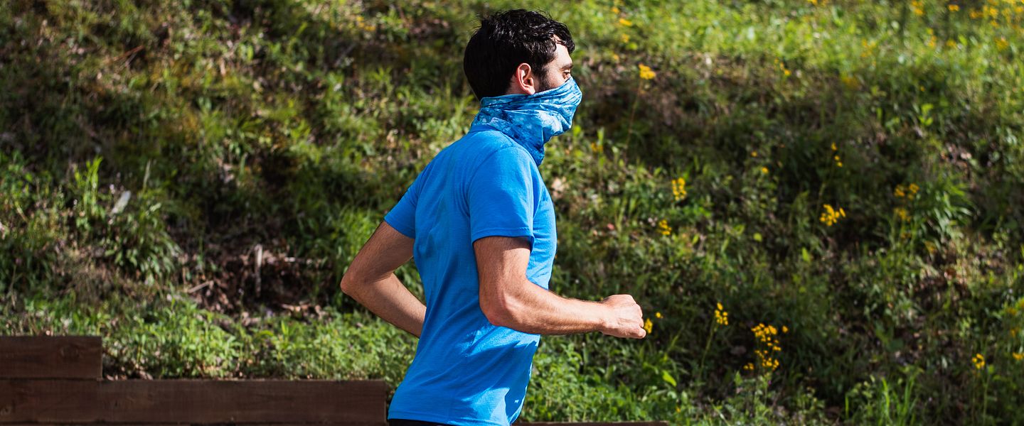 man running with face covering