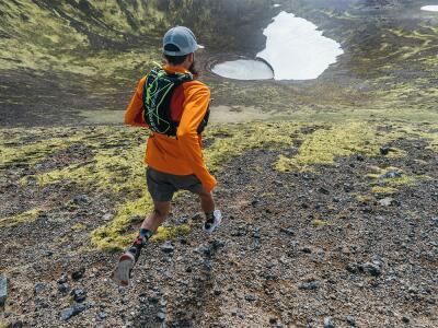 man in hydration vest on trail run