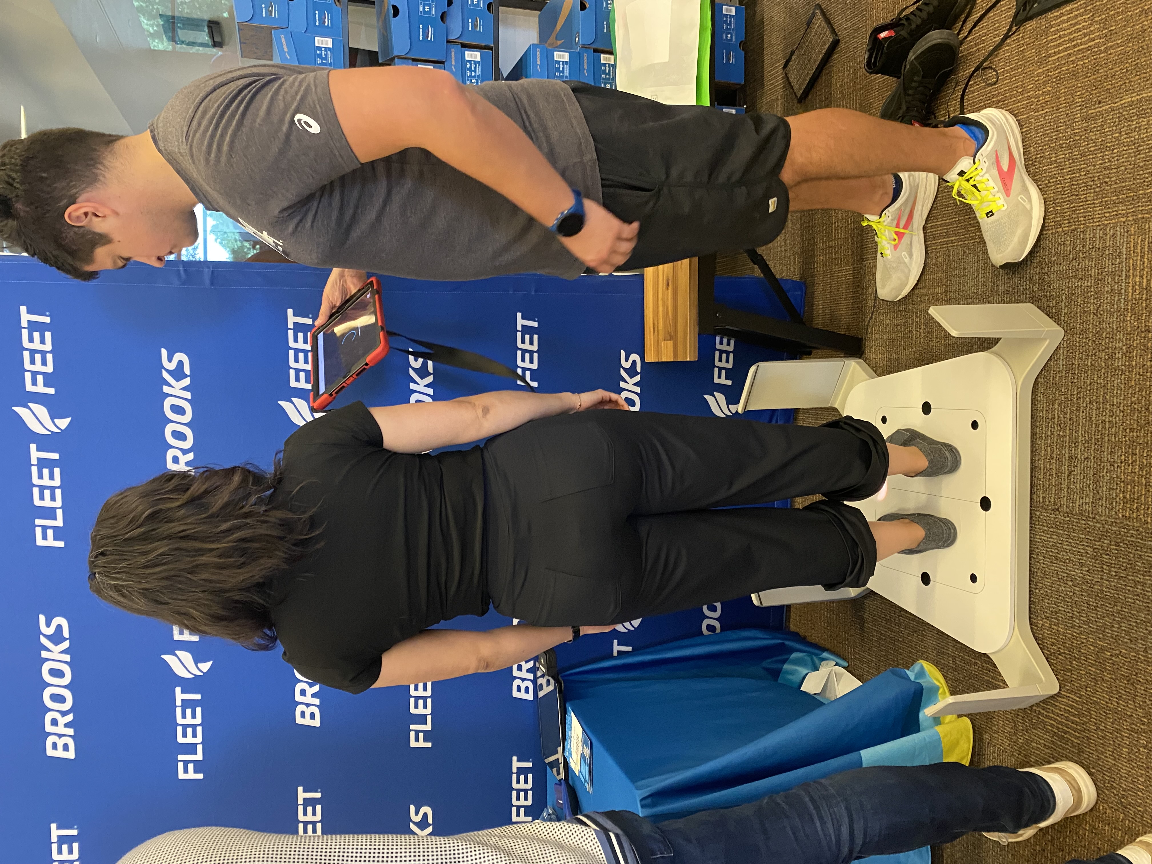 An outfitter scanning an employee's feet at a health fair