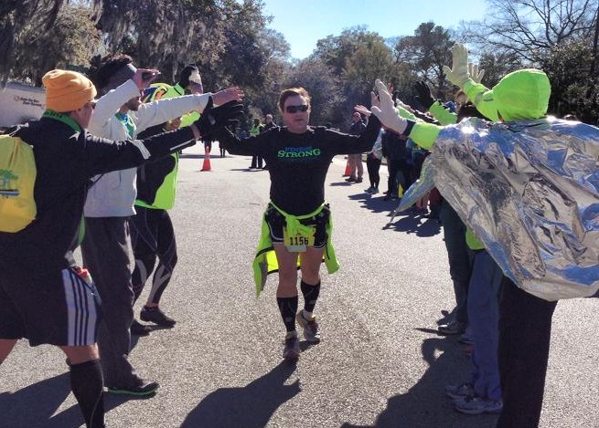 Greg Sipf at the Charleston Marathon high fiving his teammates
