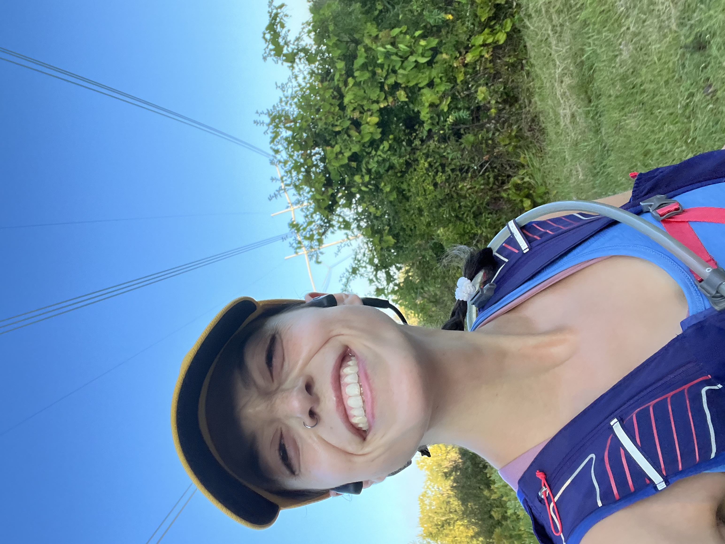 women wearing a hat taking a picture of herself on a run