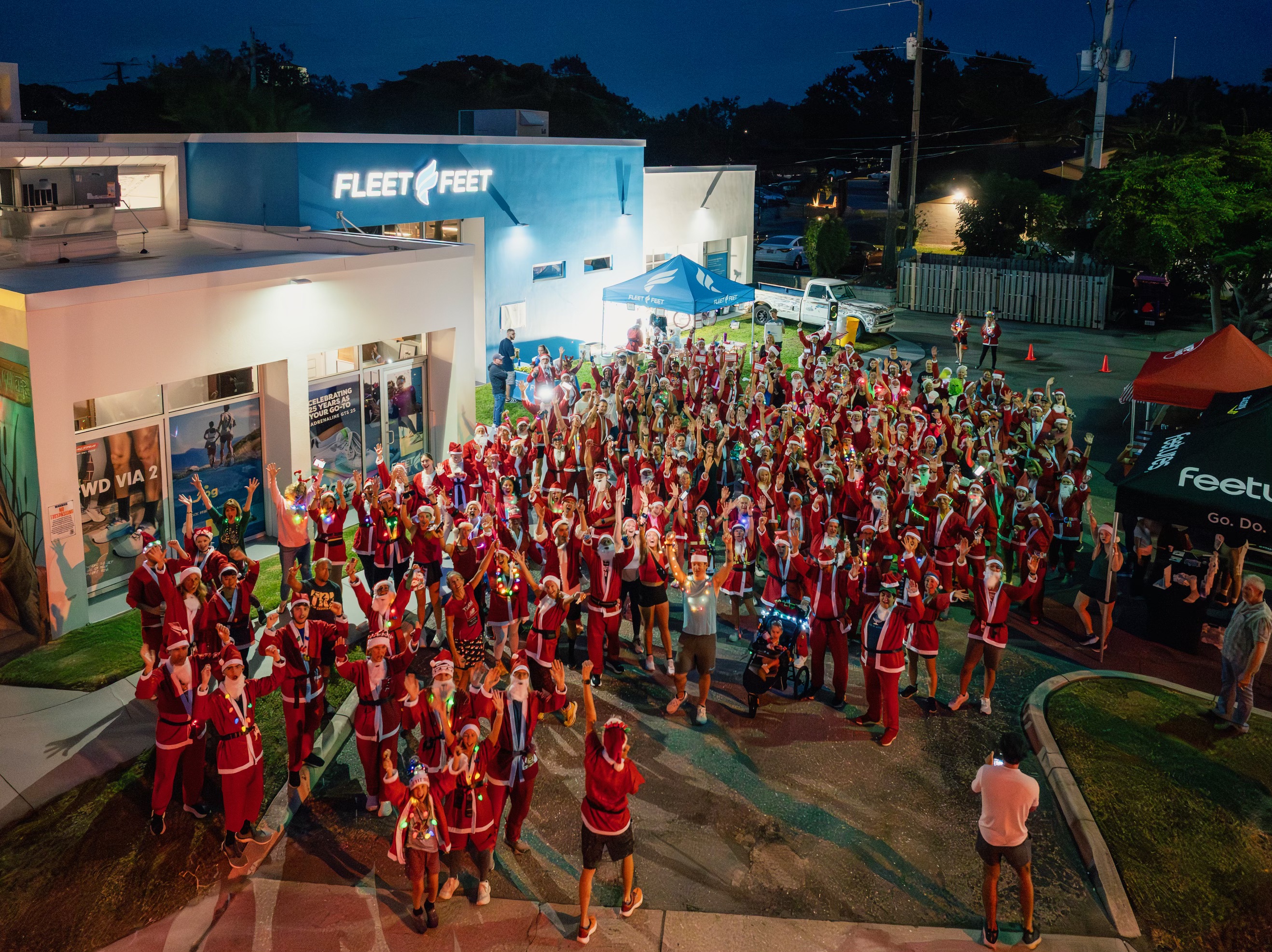 Santas running outside Fleet Feet