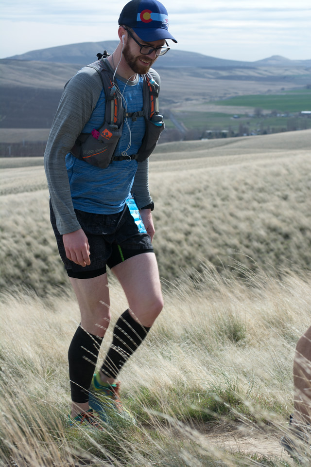 Chris Mellott trail running in tall grass