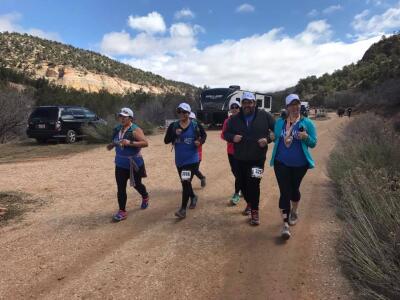 Team Idahomies running Nick in to the finish line at the Zion Half