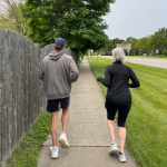 Coach and training participant running together