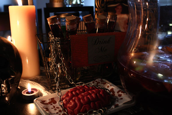 Halloween table decorations, candles, test tube shots, brain, chain, sangria