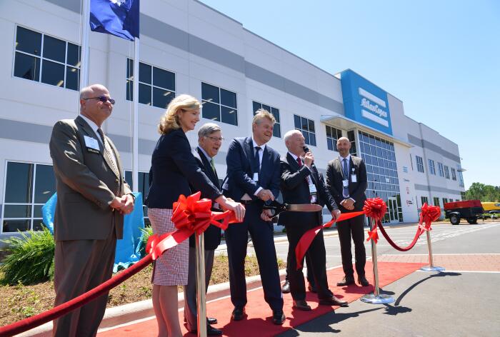 Atlas Copco executives along w/ local & state officials cut ribbon  