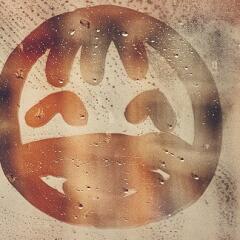 Smiley face drawn in the fog of a mirror