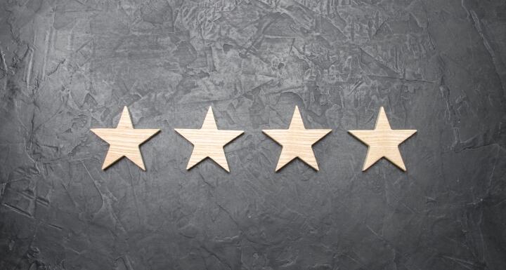 Four gold stars along a grey wall