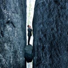 A business man stuck between a rock and hard place