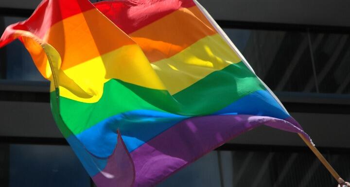 Closeup of a rainbow pride flag waving in the wind