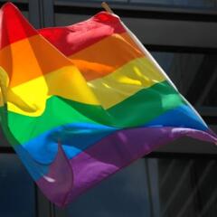 Closeup of a rainbow pride flag waving in the wind