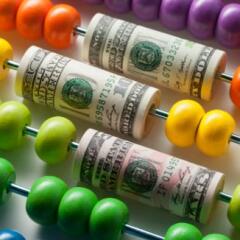 Abacus with rolls of dollar banknotes