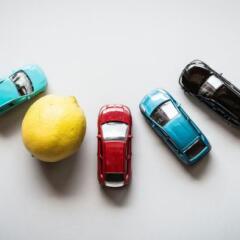 Aerial view of toys cars and a lemon in circle 