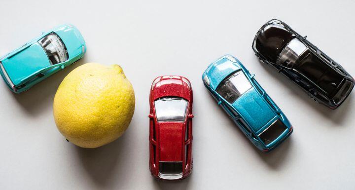 Aerial view of toys cars and a lemon in circle 