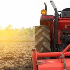 Red Tractor plowing field