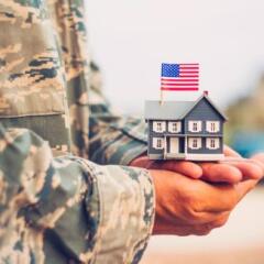 American Military Soldier holding house