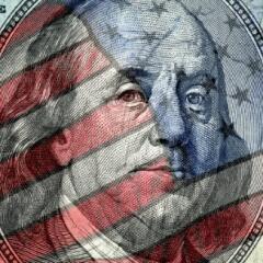 American Flag superimposed on a one hundred dollar bill