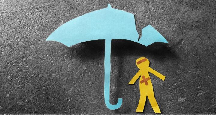 bandaged paper man under cracked umbrella