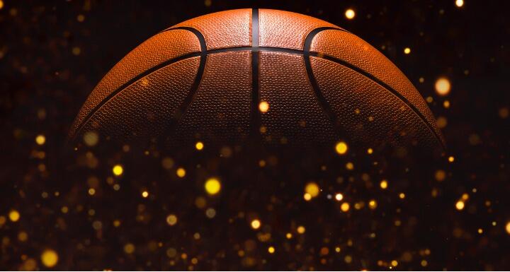 Close up on basketball ball on a black background with glitter