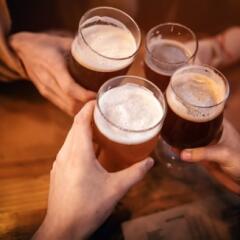 four friends toasting with beer