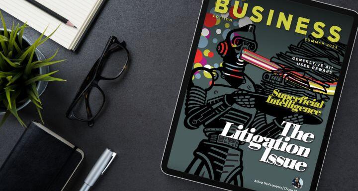 Ipad on desk with glasses and notepad