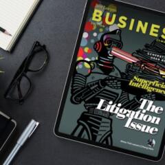 Ipad on desk with glasses and notepad