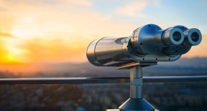 Binoculars or telescope on top of skyscraper at observation deck