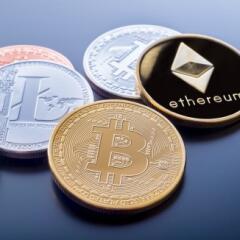 Coins with the logos of Bitcoin and Ethereum stamped on the faces