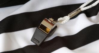 Black and white referee shirt with black whistle