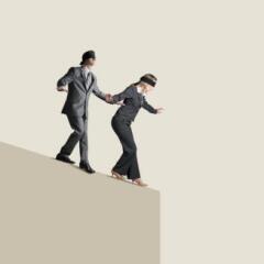 Blindfolded Man And Woman Attempting To Navigate Their Way