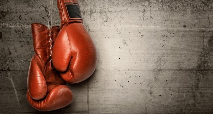 Boxing gloves hanging on concrete wall