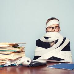 Boy accountant overwaorked and cover receipt tape