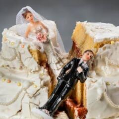 destoryed wedding cake with bride and groom topper