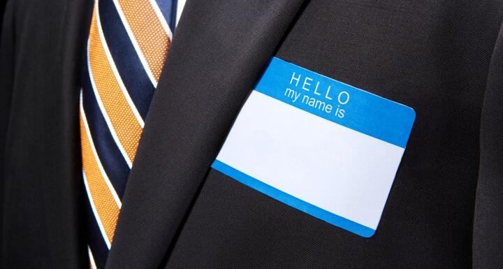 Businessman with blank, blue name tag sticker