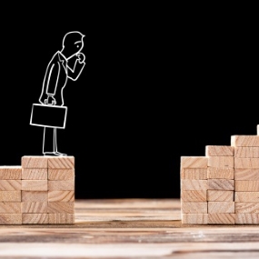 Cartoon chalk man pondering gap between two wooden blocks