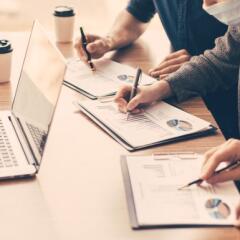 coworkers in masks working together at desk