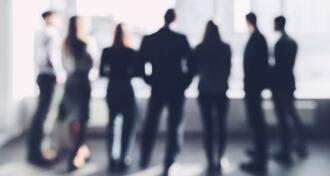 Business team looking through window, blurred