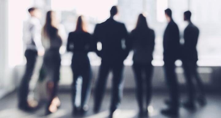 Business team looking through window, blurred