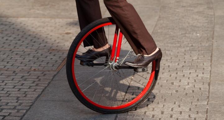 Business woman go to work in monocycle