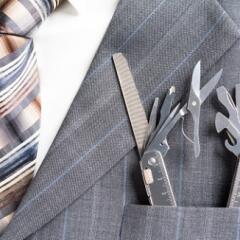 Close up of business man in suit with tools in suit lapel pocket