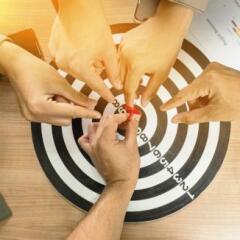 Businessman Point to a darts aiming at the target center business