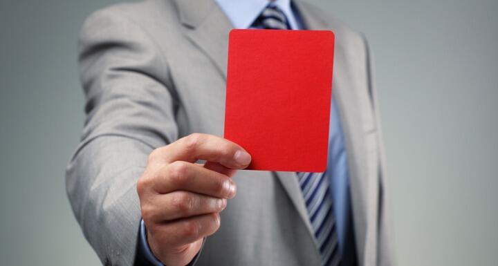 Business man holding red card