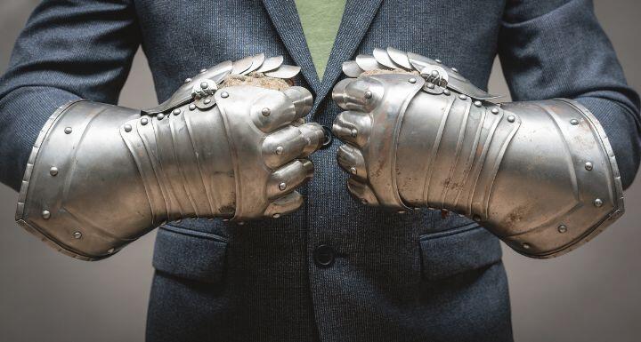 Businessman hands in the plate armor mittens close up