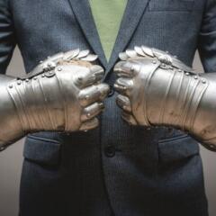 Businessman hands in the plate armor mittens close up