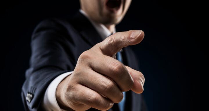 Businessman sticks out a finger 