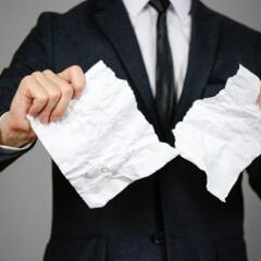 man in a suit tearing up paper signifying a trademark license