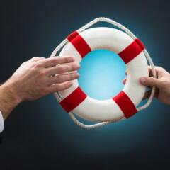 Businessmen Passing Lifebuoy Over Blue Background