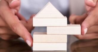 A small house made of Jenga blocks