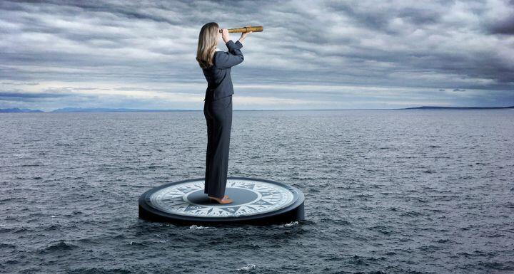 Business Woman Stands on Compass looking through spyglass in stormy Sea